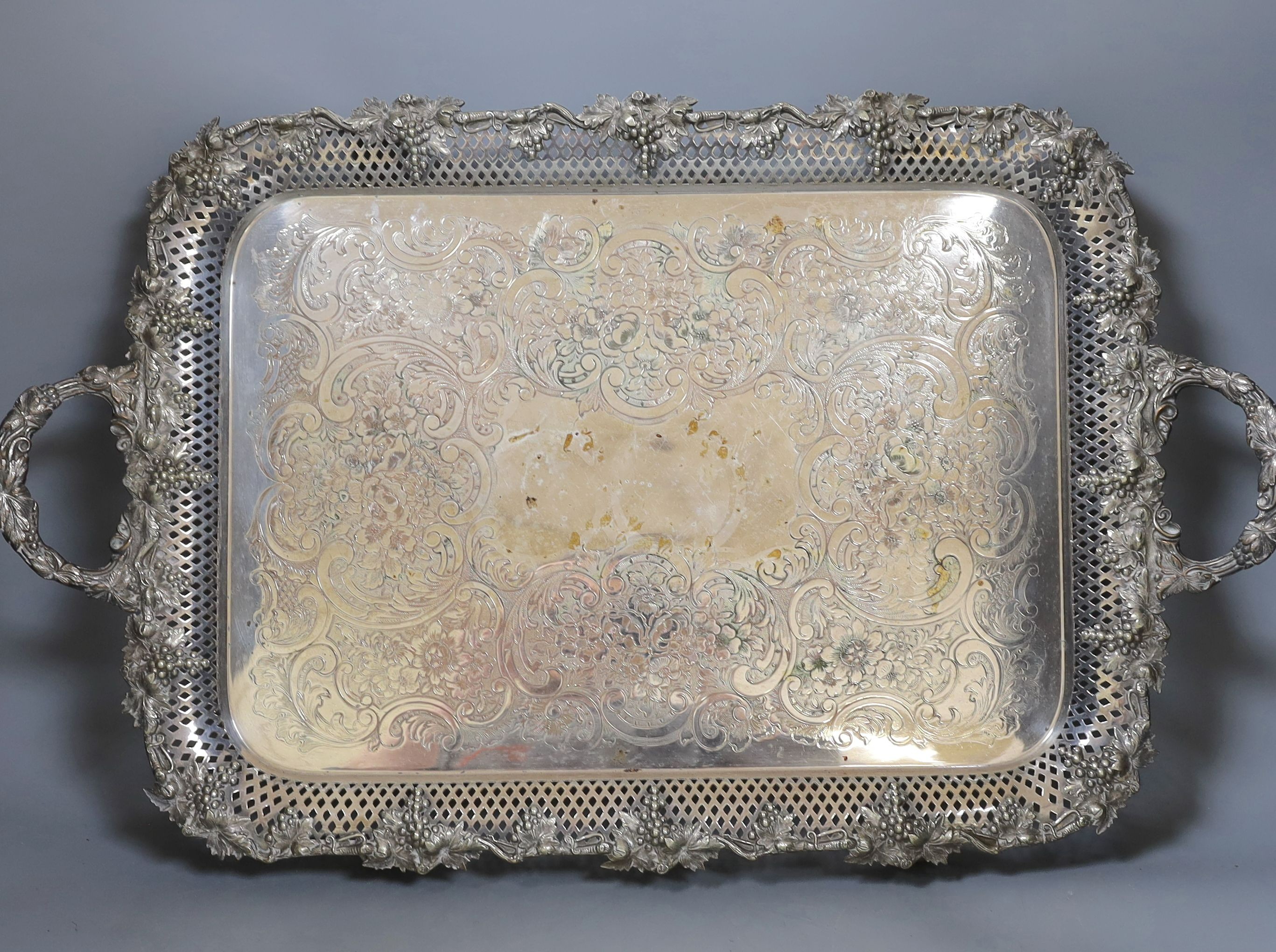 A large electroplate two handled tray, with pierced and vine decoration, 51 cms wide not including handles.